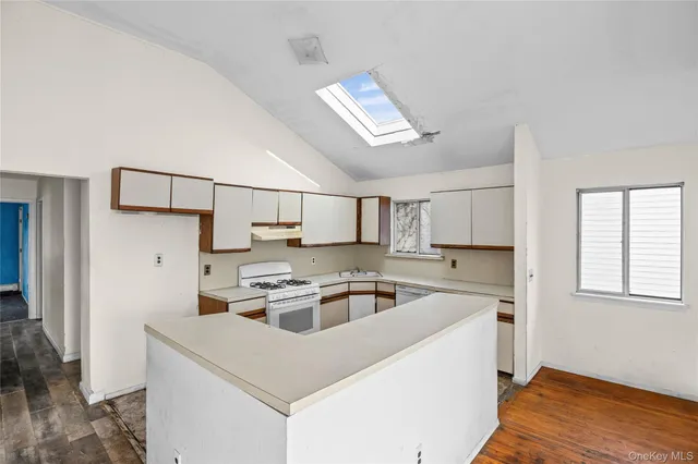 a kitchen that has a sink and a stove top oven