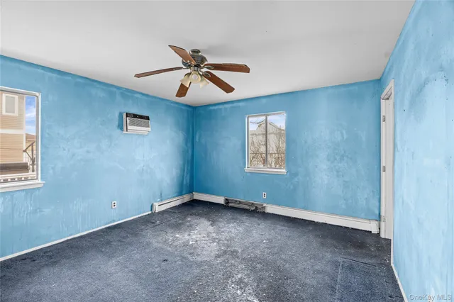 a view of room with a ceiling fan and window