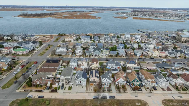 an aerial view of a building and ocean view