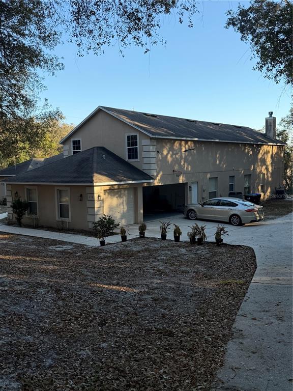 218 Piney Woods Road Apopka, FL 32703 - Photo 2 of 11 a backyard of a house with yard fire pit and outdoor seating