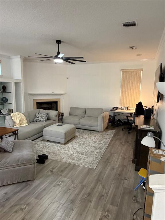 218 Piney Woods Road Apopka, FL 32703 - Photo 6 of 11 a living room with furniture and a chandelier