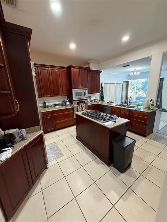 218 Piney Woods Road Apopka, FL 32703 - Photo 7 of 11 a kitchen with a stove a sink a microwave and cabinets