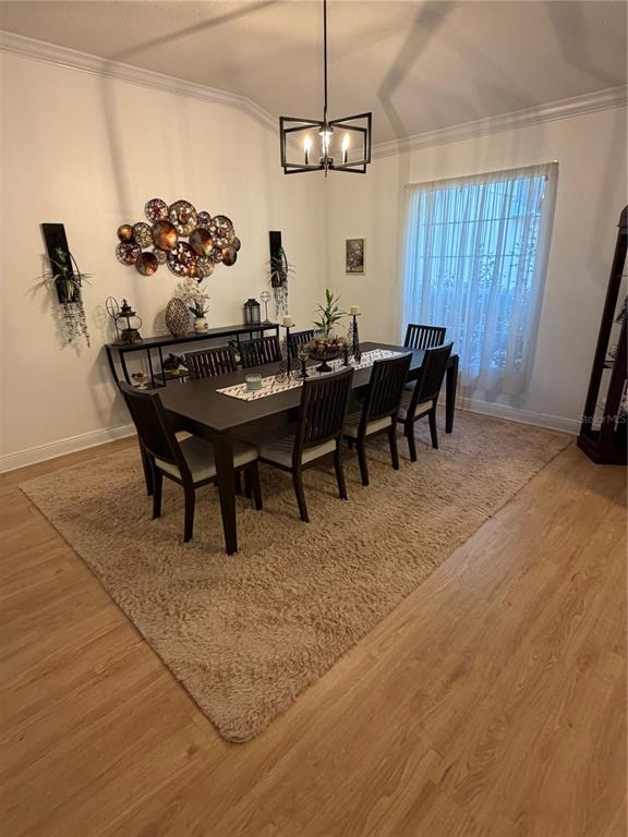 218 Piney Woods Road Apopka, FL 32703 - Photo 8 of 11 a view of a dining room with furniture and chandelier