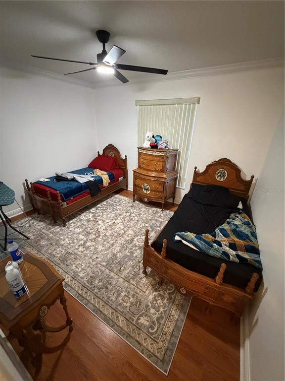 218 Piney Woods Road Apopka, FL 32703 - Photo 10 of 11 a bedroom with a bed and dresser