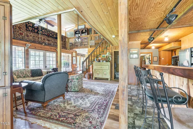 a living room with furniture and a floor to ceiling window