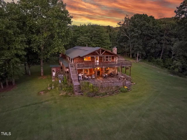 a backyard of a house with lots of green space and plants