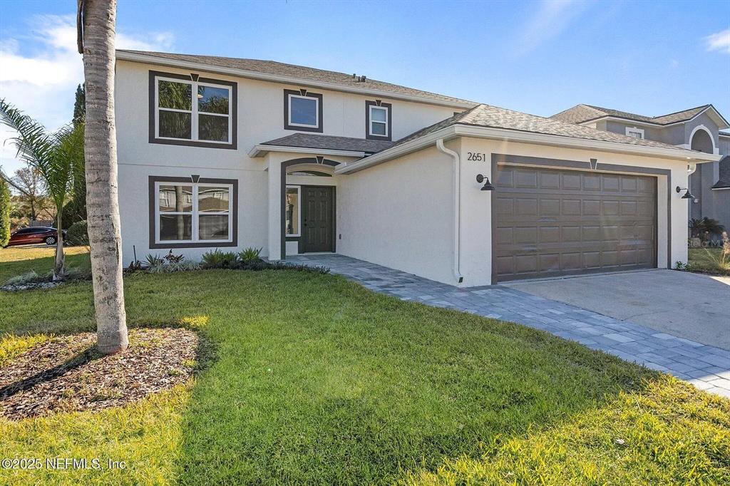 a view of a house with a yard