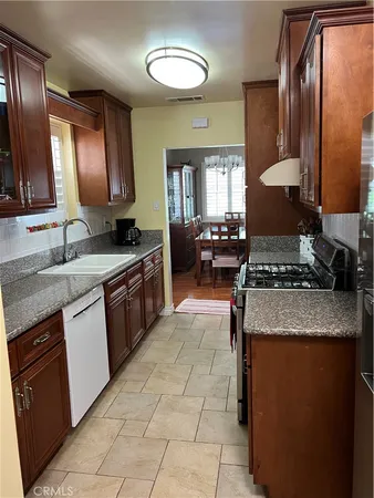 a kitchen with a stove top oven sink and cabinets