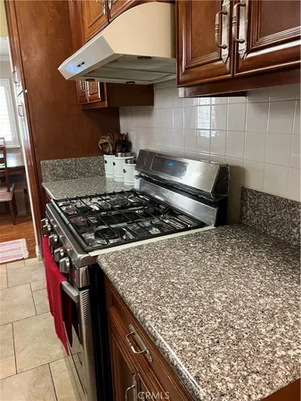 a stove top oven sitting inside of a kitchen
