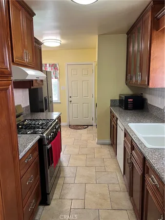 a bathroom with a granite countertop sink and a window
