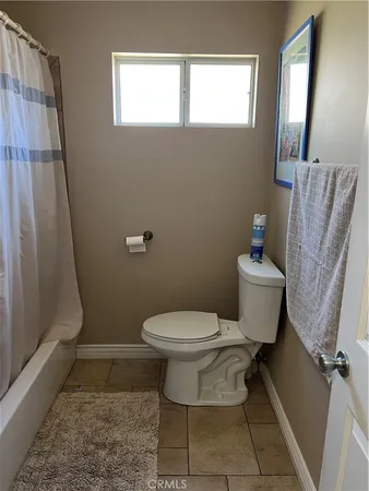 a bed sitting in a bedroom next to a lamp