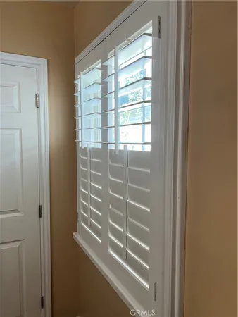 a view of balcony with two chairs and a yard