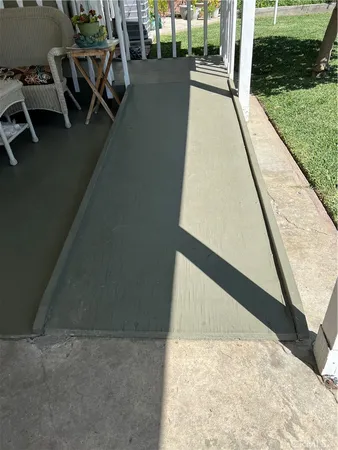 a view of a backyard with potted plants and large trees