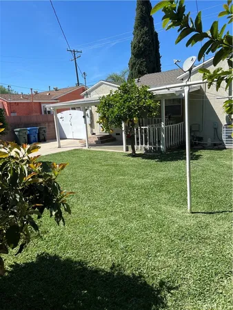 a view of a patio with table and chairs with wooden floor and fence