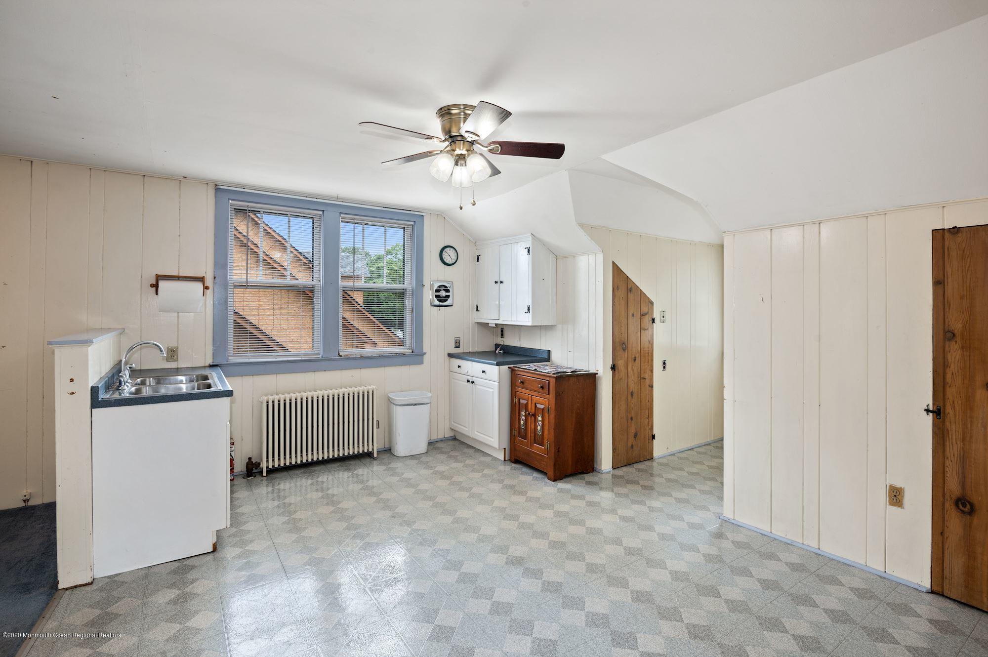 306 Cedar Road Point Pleasant, NJ 08742 - Photo 17 of 28 a kitchen with stainless steel appliances a stove a refrigerator a sink a oven with white cabinets and wooden floor