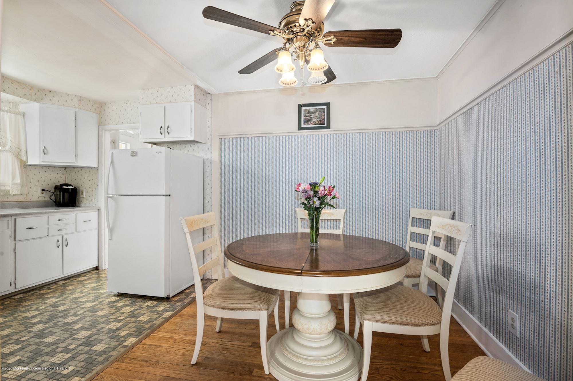 306 Cedar Road Point Pleasant, NJ 08742 - Photo 3 of 28 a kitchen with stainless steel appliances granite countertop a dining table chairs and a refrigerator