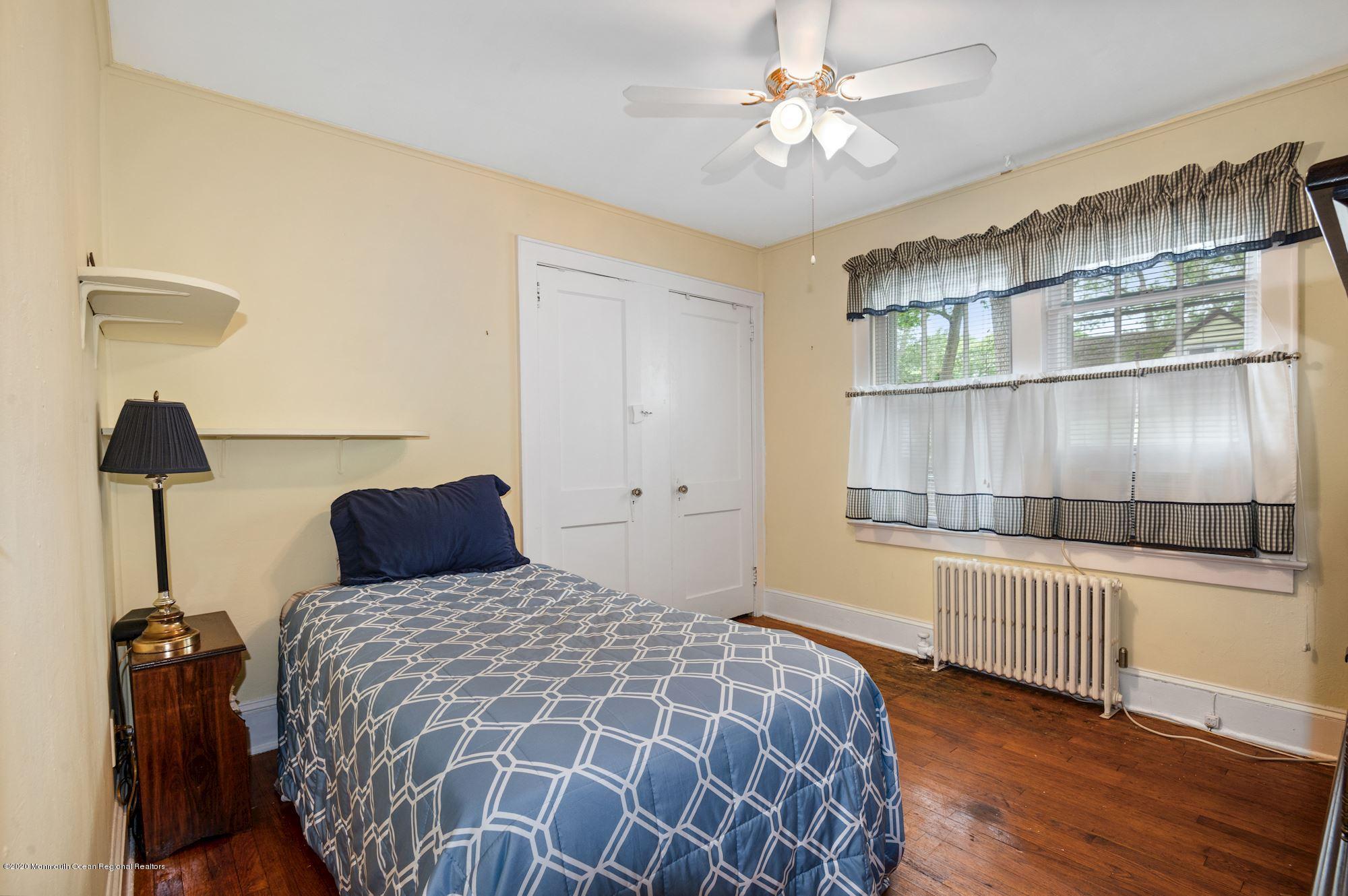 306 Cedar Road Point Pleasant, NJ 08742 - Photo 10 of 28 a bedroom with a bed and a chandelier