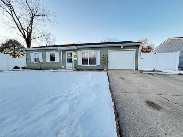 a front view of house with yard and trees