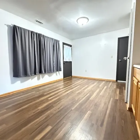 a view of front door with wooden floor