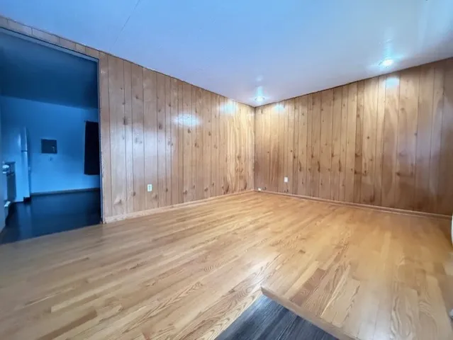 a view of an empty room with wooden floor