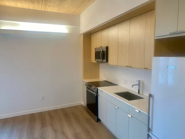 a view of a kitchen with electric appliances