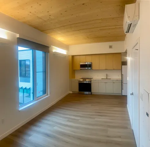 a view of a kitchen with a sink and a refrigerator