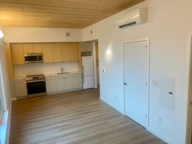 a kitchen with stainless steel appliances granite countertop a sink and a refrigerator