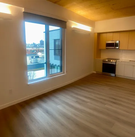 a view of kitchen and wooden floor