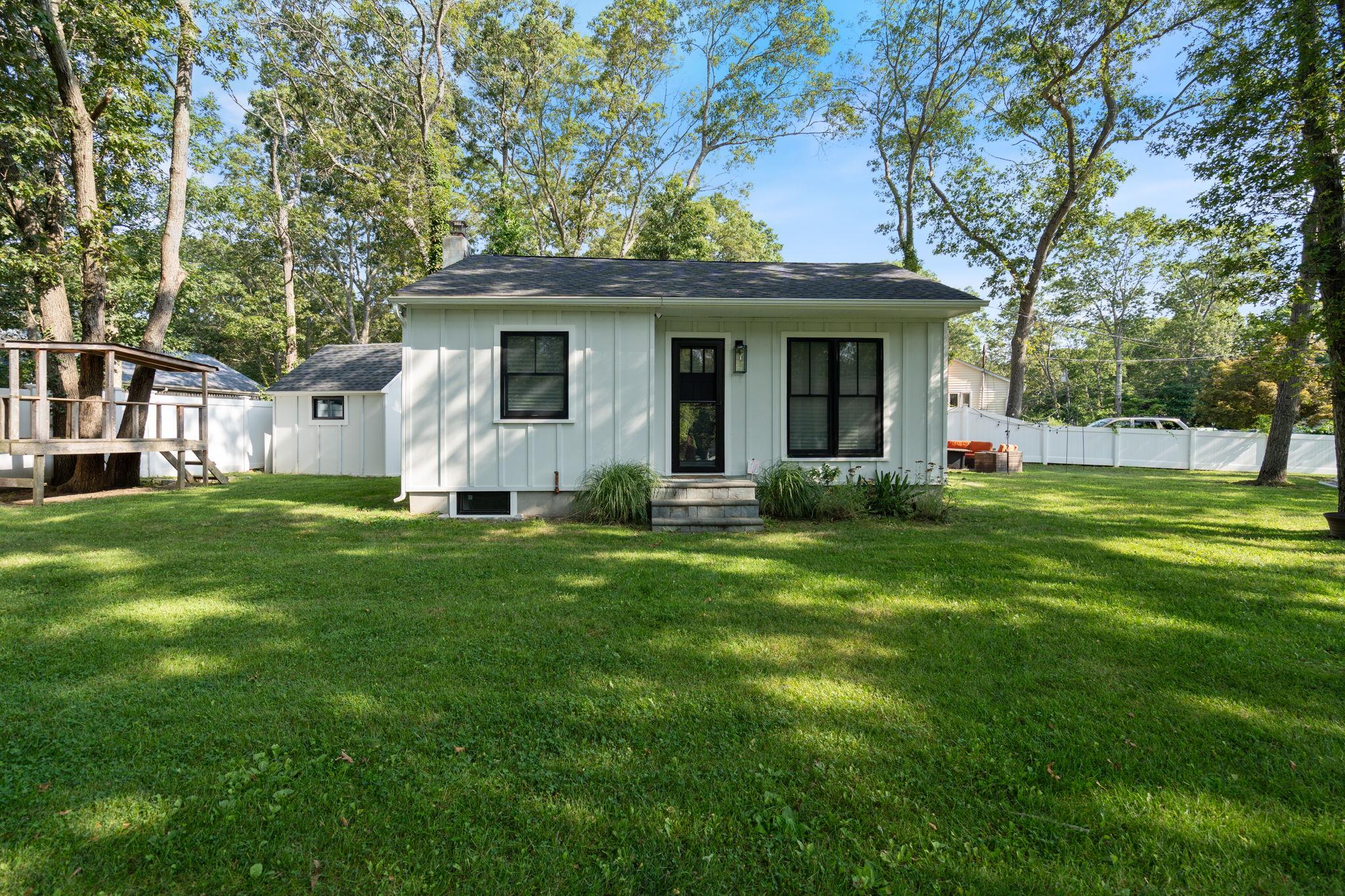 a front view of house with yard and green space