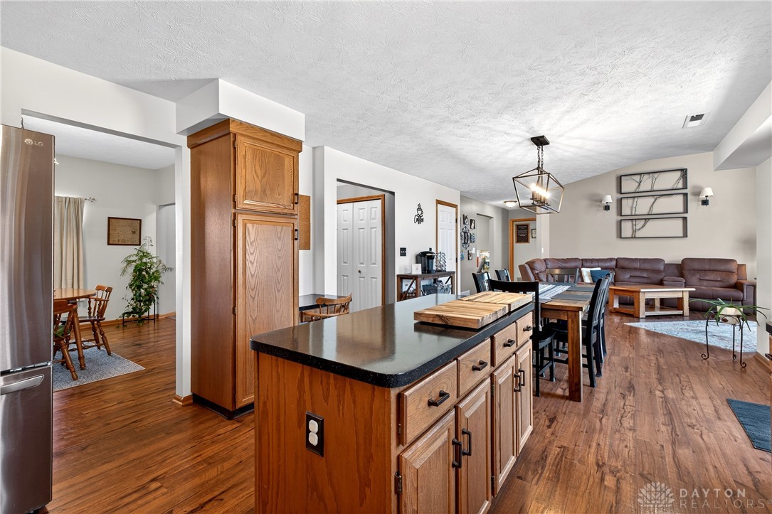 6560 Snyder Road Fletcher, OH 45326 - Photo 23 of 71 An inviting open-concept layout connects the well-appointed kitchen to a comfortable living area.
