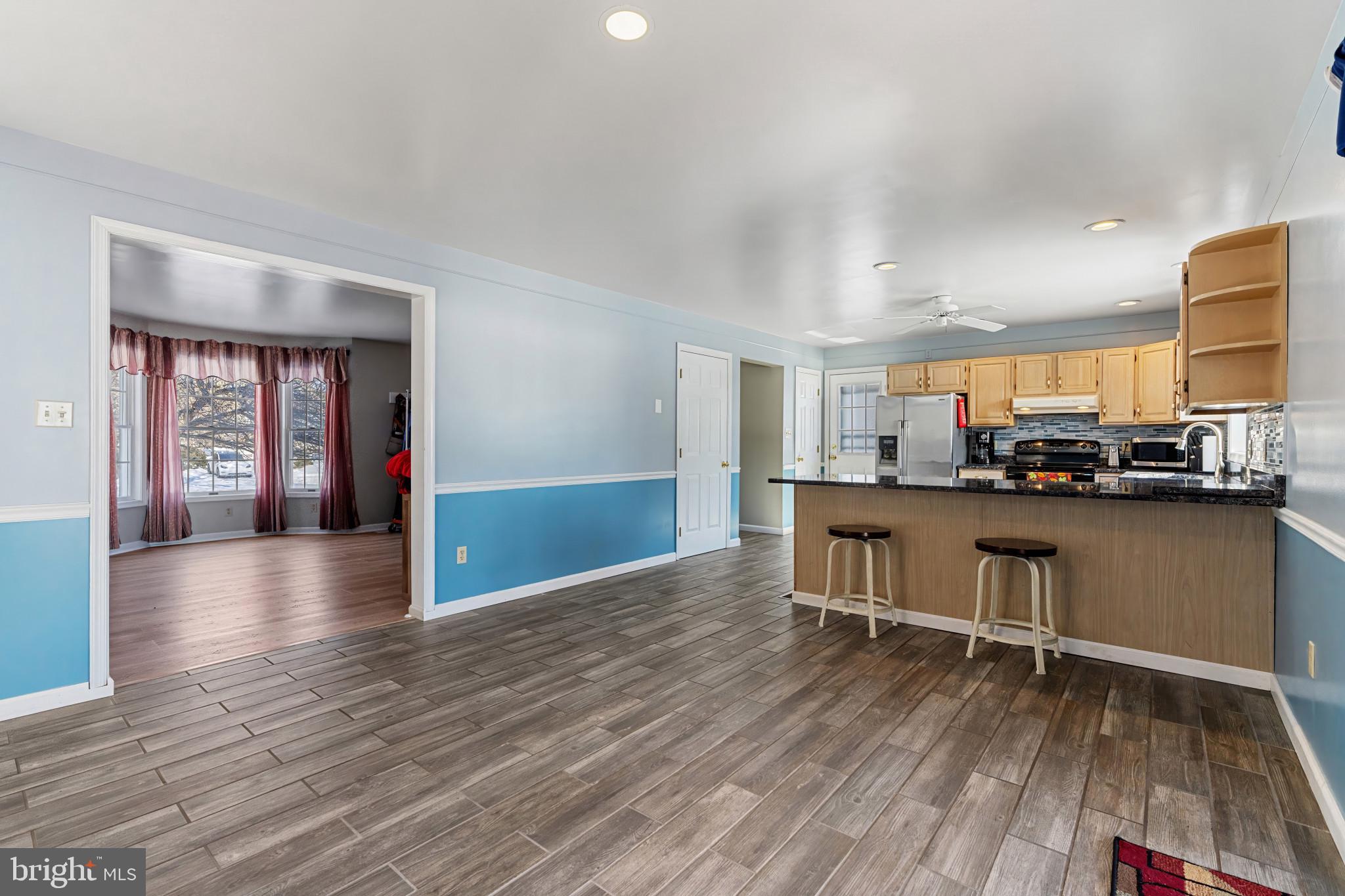 14525 John Peel Road Galena, MD 21635 - Photo 11 of 31 a view of a kitchen with furniture and wooden floor