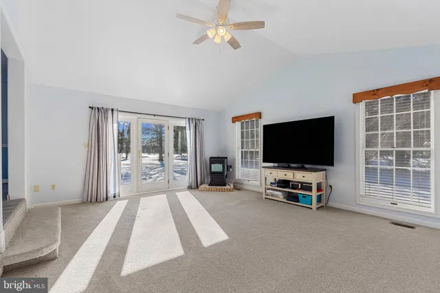 a view of a livingroom with furniture and a flat screen tv