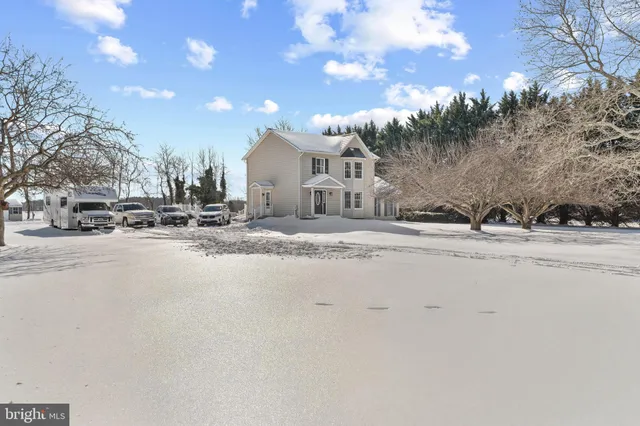 a view of a house with a snow on the road