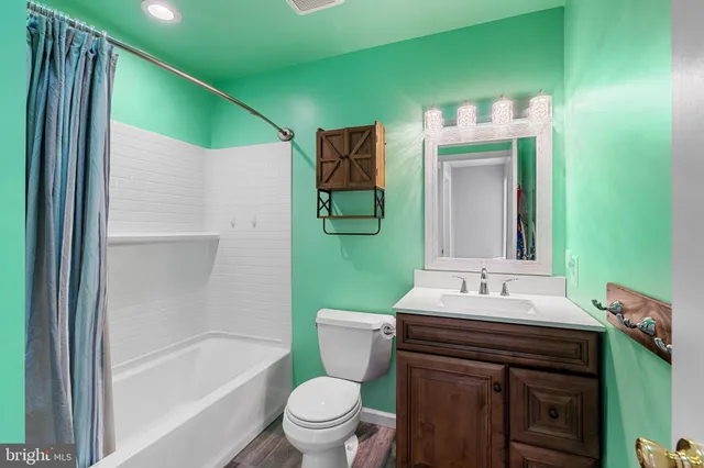 a bathroom with a sink toilet and tub