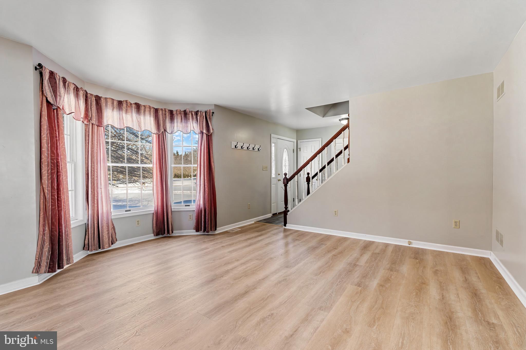 14525 John Peel Road Galena, MD 21635 - Photo 5 of 31 a view of an empty room with wooden floor and a window