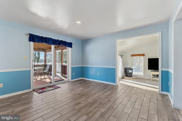 a view of a livingroom with wooden floor and a fireplace