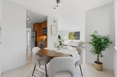 a view of a livingroom with furniture and a potted plant