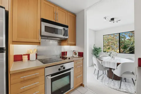 a kitchen with a stove a sink and a microwave