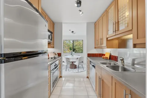 a kitchen with a sink stove and cabinets