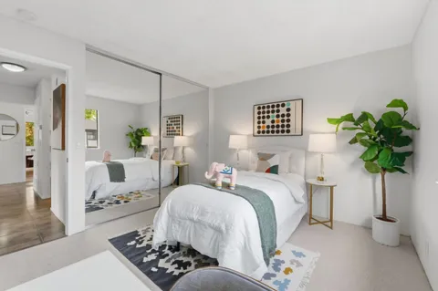 a bedroom with a bed and a couch