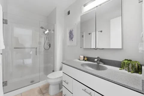 a bathroom with a sink toilet and shower