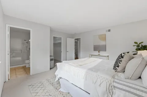 a bedroom with a bed and a mirror