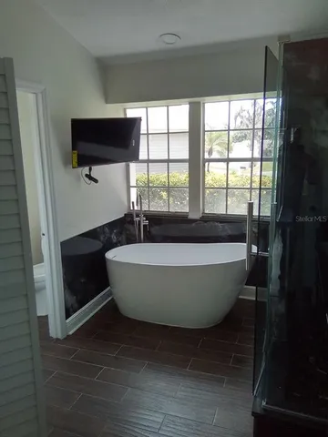 a living room with a window and a flat screen tv