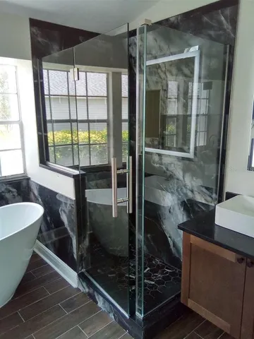 a bathroom with a bathtub and a shower