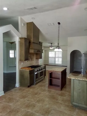 a kitchen with granite countertop a stove and a sink