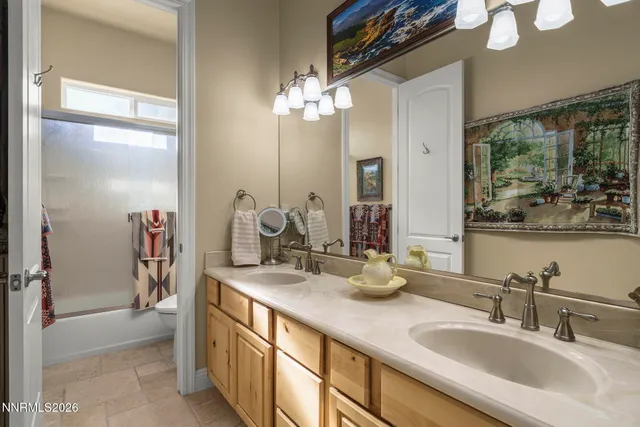 a bathroom with a double vanity sink and a mirror