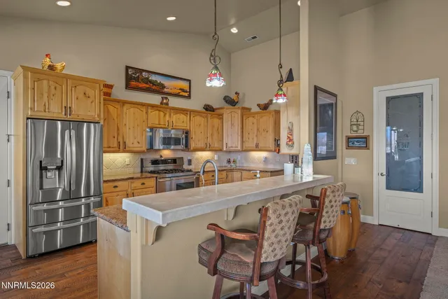 a kitchen with stainless steel appliances a refrigerator and a stove