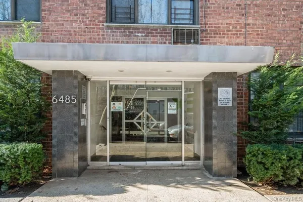 front view of a building with a potted plant
