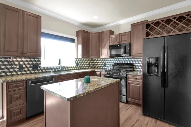 a kitchen with a sink stove and refrigerator