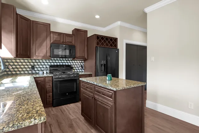 a kitchen with stainless steel appliances granite countertop a stove and a sink